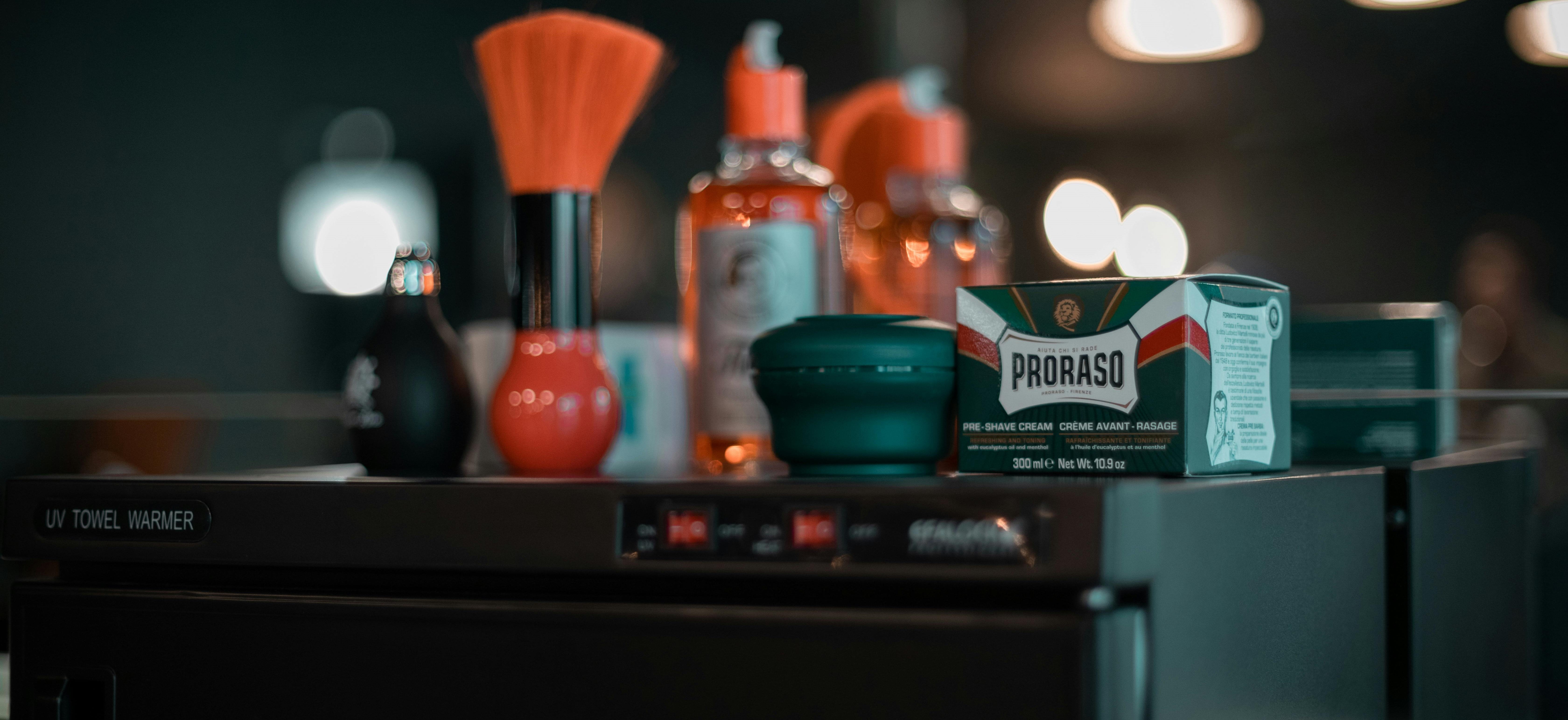 A brush, and a bottle of toner, alongside various beauty products.